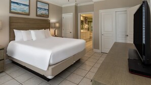 Een hotelkamer met een groot bed, nachtkastjes, een bureau en een televisie.
