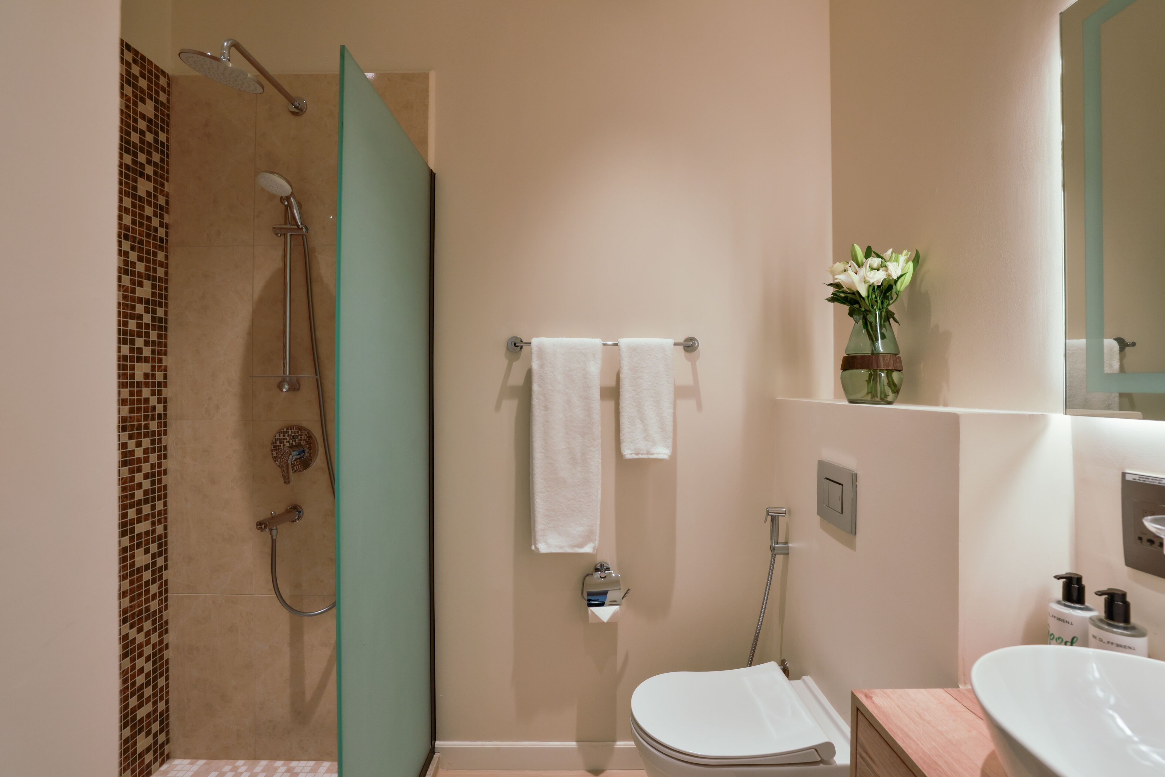 A bathroom with a shower, toilet, and sink.