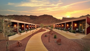 A hotel with a desert landscape in the background, featuring a central walkway and multiple rooms with outdoor seating. - Cloud 7 Residence AlUla (Al-'Ula)
