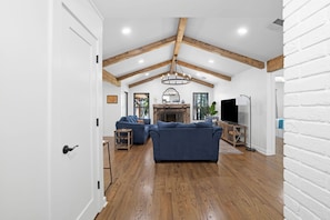 A spacious living room with a fireplace, wooden beams, and a large sofa set. - Lakefront, Views, Private Dock, Boat Rental, Bunks, Near Clemson, Kayaks! (Starr)