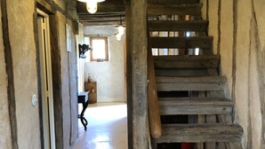 A rustic wooden staircase with a handrail, leading to a room with a window and a door. - 4 Bedroom Private vacation home in Montpezat (Montpezat)