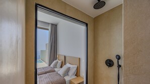 A hotel room with two beds, a shower, and a view of the outside. - Pyrgos Exquisite villa 3 ,private pool,South Crete (Plakias)