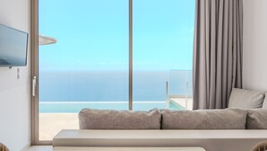 A room with a large sliding glass door leading to a balcony with a view of the ocean. - Pyrgos Exquisite villa 5 ,private pool,South Crete (Plakias)