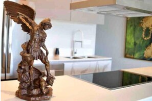 A statue of an angelic figure in a modern interior setting. - Náutico: Hermosa Vista al Muelle (Puerto Vallarta)