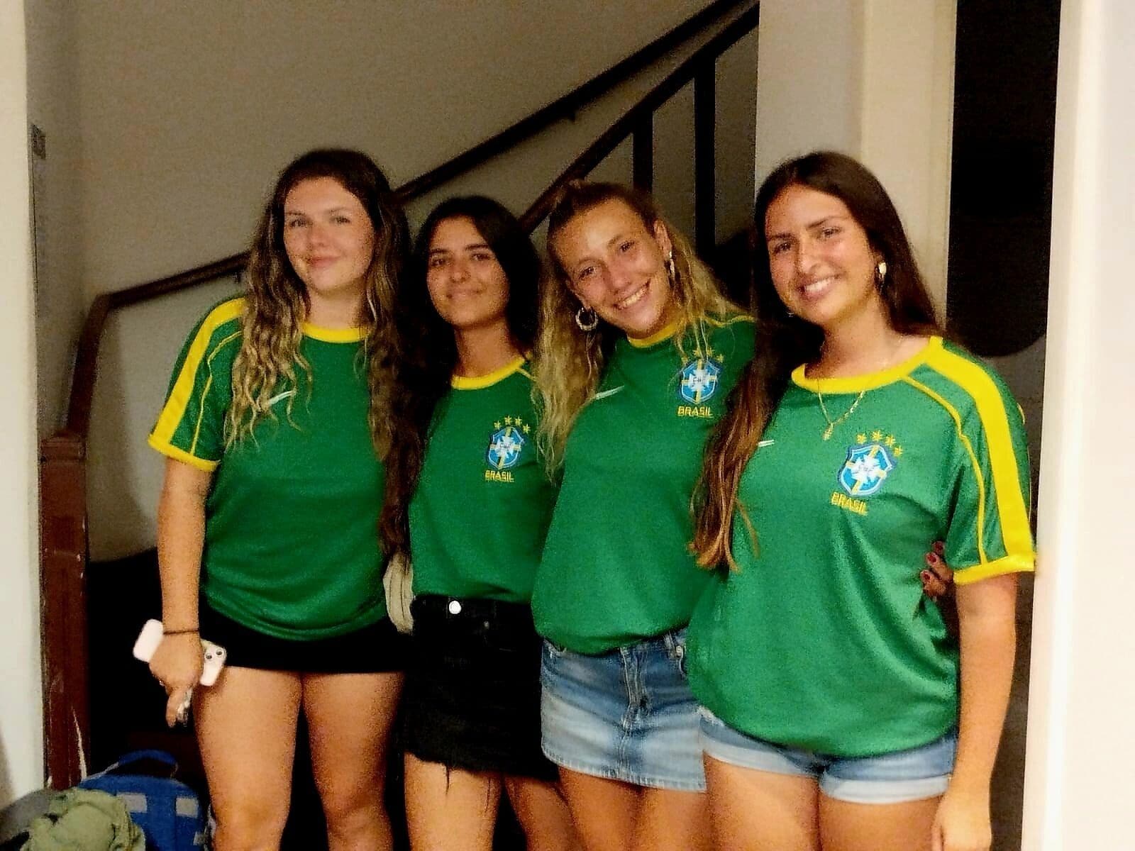 Four individuals wearing green and yellow sports jerseys.