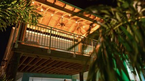 Ein Holzhaus mit Balkon und Deckenventilator.