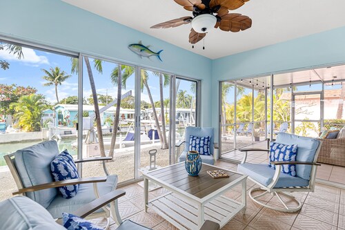 Single-level waterfront home with furnished Florida room, dock, washer/dryer