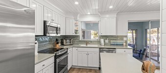 Single-level waterfront home with furnished Florida room, dock, washer/dryer