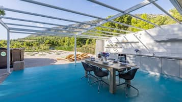 Enjoy al fresco dining with a view of the surrounding hills and lush greenery.