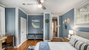 A bedroom with a bed, a desk, a chair, a ceiling fan, and a view of the hallway. - Spacious 4br/3ba Park Circle Home. Great Location! (North Charleston)