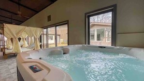 A hot tub with a control panel, a window, and a view of the outside.