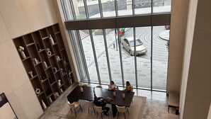 A modern interior with a large window overlooking a parking area.