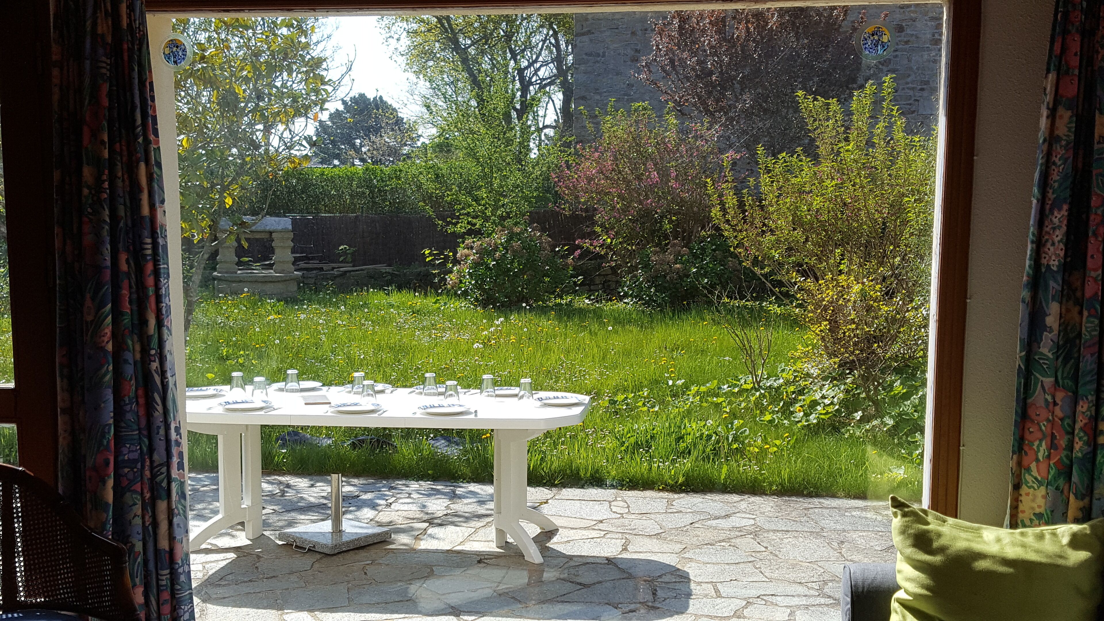 A table set outdoors with a garden view.