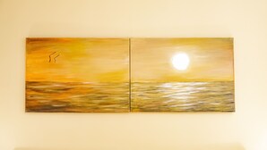 A two-panel painting of a sunset over water. - Sun&Moon Apartment (Bari)