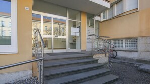 A building entrance with a staircase, a bicycle rack, and a sign indicating the address. - 3 bedroom nice apartment in Rovereto (Rovereto)