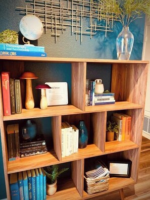 Una prestatgeria de fusta amb llibres i objectes decoratius.