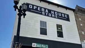 A building with a sign reading "Opera House Store" and a "Do Not Enter" sign. - Opera House Suite 1 (Kemmerer)