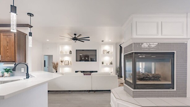 A modern kitchen with a central island, built-in appliances, and pendant lighting. - Contemporary Haven Retreat w/ KING BED Suite (Amarillo)