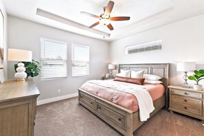 A bedroom with a bed, bedside tables, a ceiling fan, and a window with blinds. - 2 Adjacent Modern Homes • Sleep 20 • Near Top Shopping, Dining & Entertainment (Meridian)