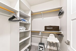 A walk-in closet with shelves, a Graco baby seat, and a step stool. - 2 Adjacent Modern Homes • Sleep 20 • Near Top Shopping, Dining & Entertainment (Meridian)