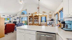 A spacious kitchen with a central island, wooden cabinets, and a dishwasher. - 4 br, 2 Min Walk to Beach, hot tub, water view (Avon)