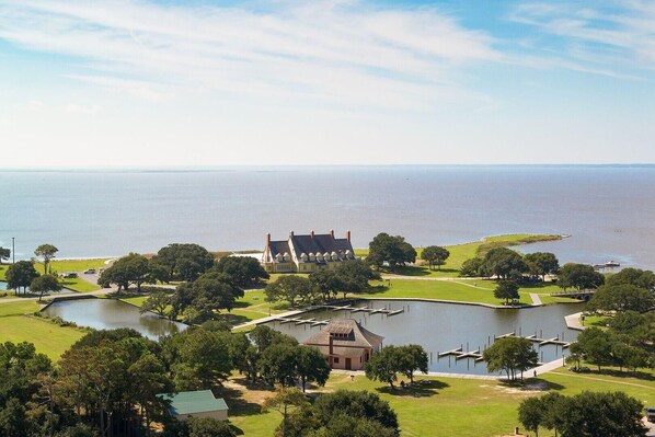 A large estate with multiple buildings, a lake, and a dock.