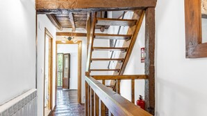 A wooden staircase with a handrail leading to an upper floor. - Holiday Home 'Casa Raymonde' with Mountain View, Balcony and Wi-Fi (Potes)