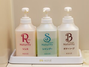 Three bottles of Natuity body soap in a white dispenser. - Hanayama Onsen Nuruyusanso Tabist (Kurihara)