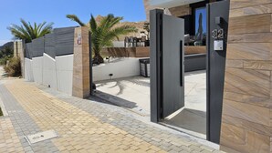 A modern building entrance with a wooden facade, a number plaque, and a clear sky. - Benidorm eudaimonia by Interhome (Benidorm)