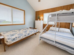 A bedroom with a bunk bed, a single bed, a dresser, and a window with blinds. - Windsurfer - Close to beach and bike path, 4 bed, 3 bath oceanside in Duck (Duck)