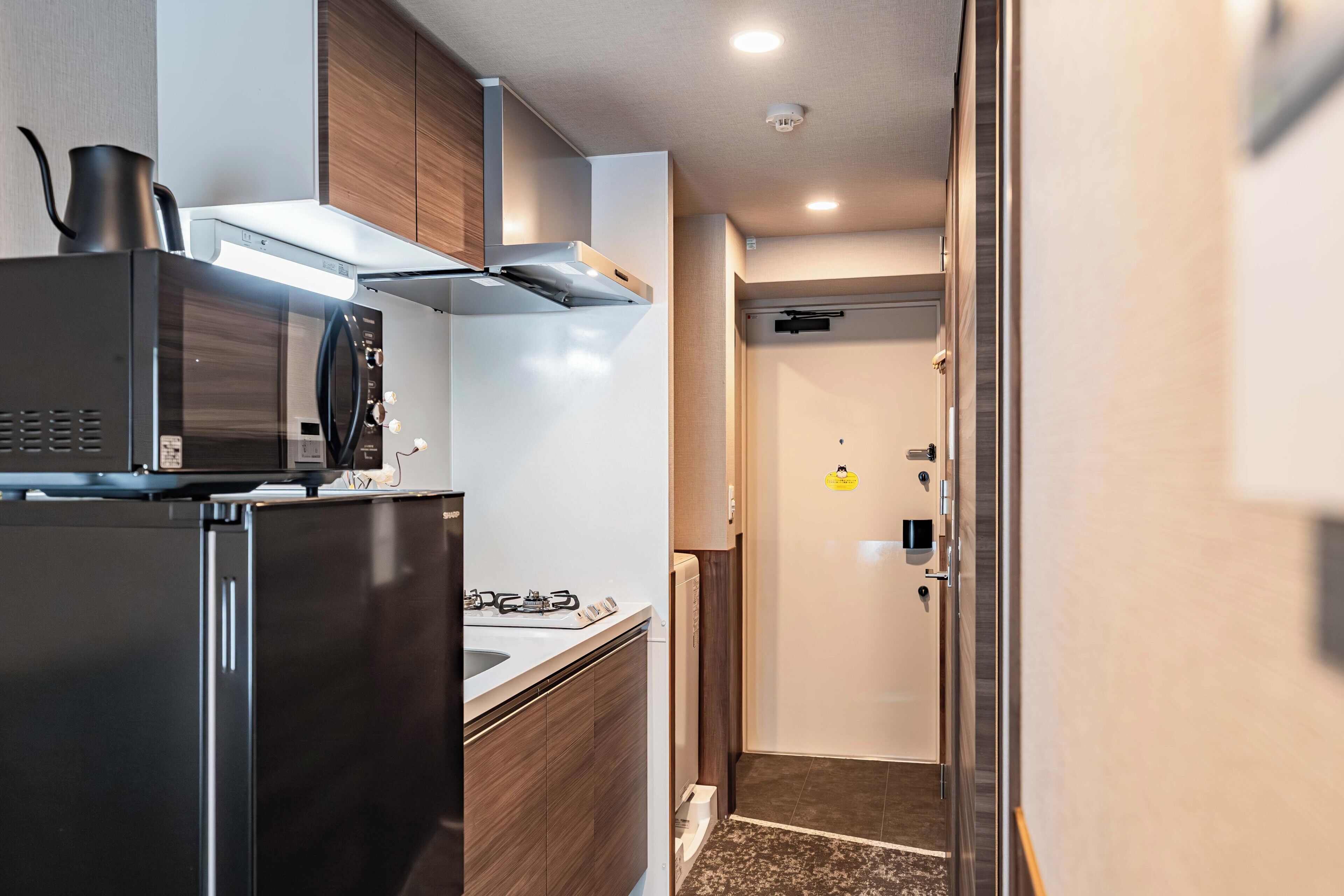 A compact kitchen with a microwave, stove, and cabinets.