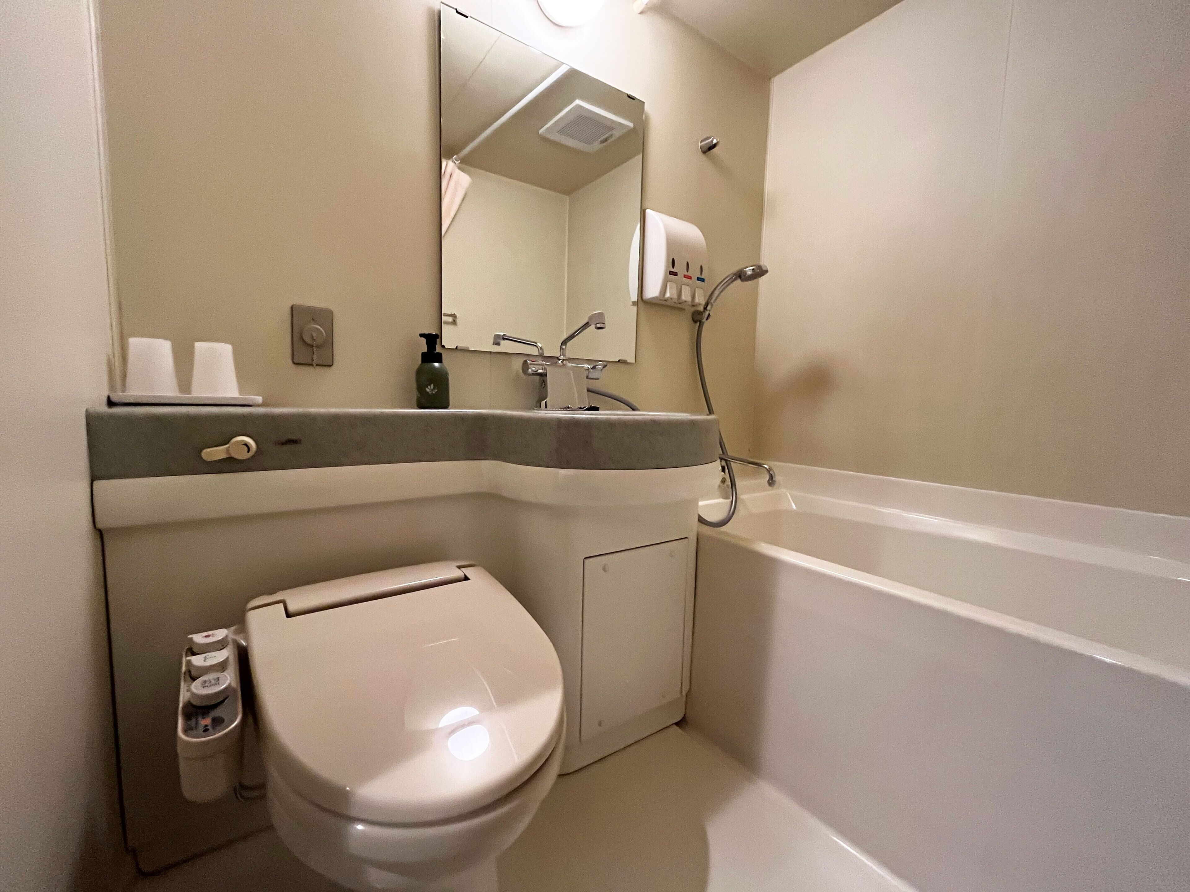 A bathroom with a toilet, sink, and bathtub.