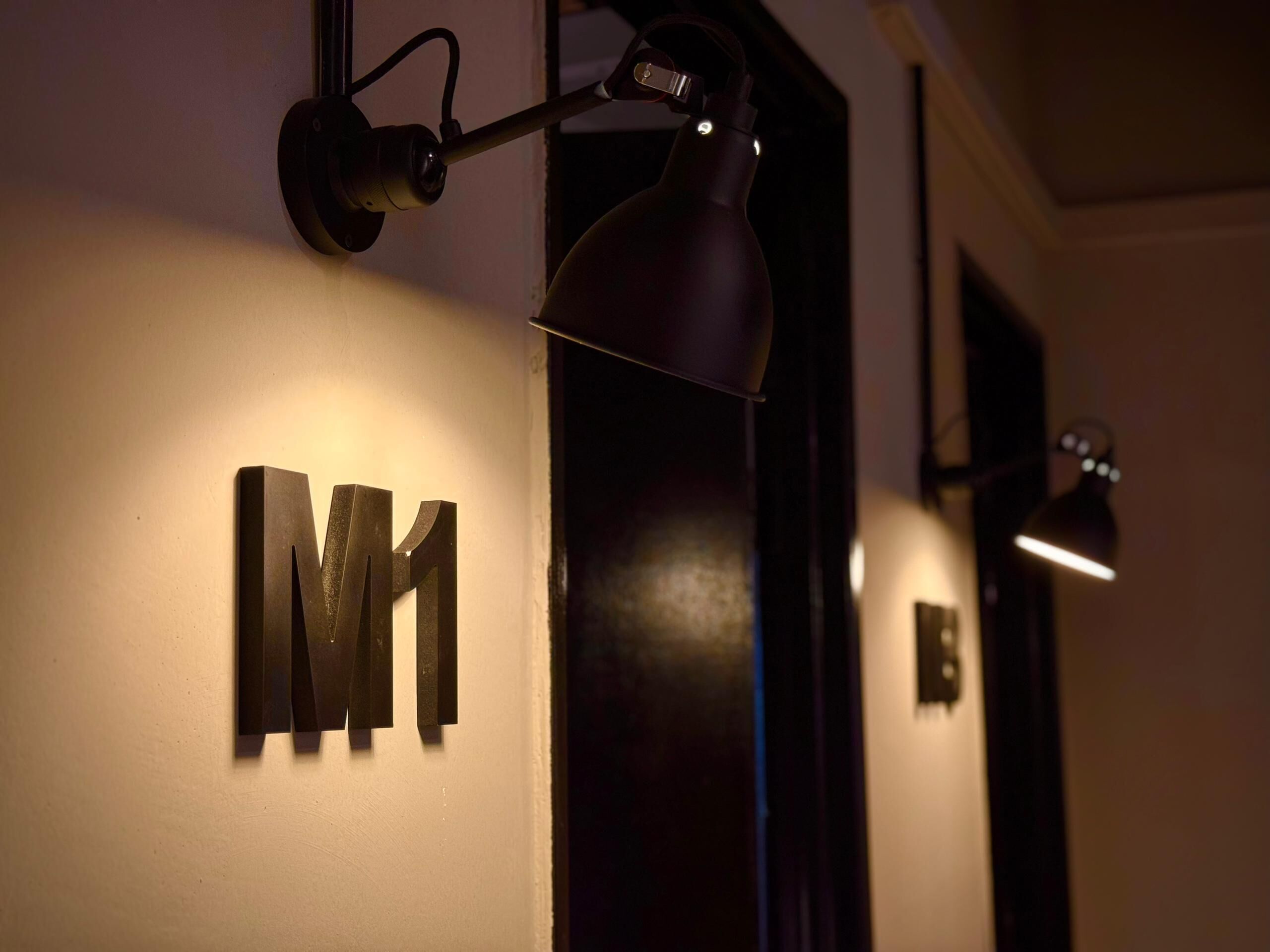 A wall-mounted sign with the letters "M1" indicating a room or section number.