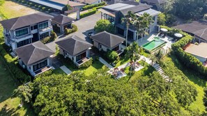 A residential complex with multiple houses, a swimming pool, and well-maintained gardens. - ProudChan Boutique Resort (Chanthaburi)