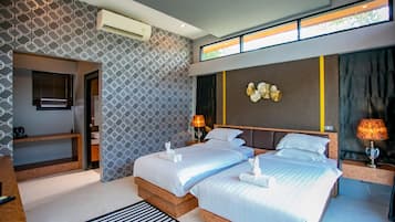 A modern hotel room with two beds, a built-in desk, and a large window.