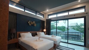 A hotel room with two beds, a large window, and a view of the outside. - ProudChan Boutique Resort (Chanthaburi)