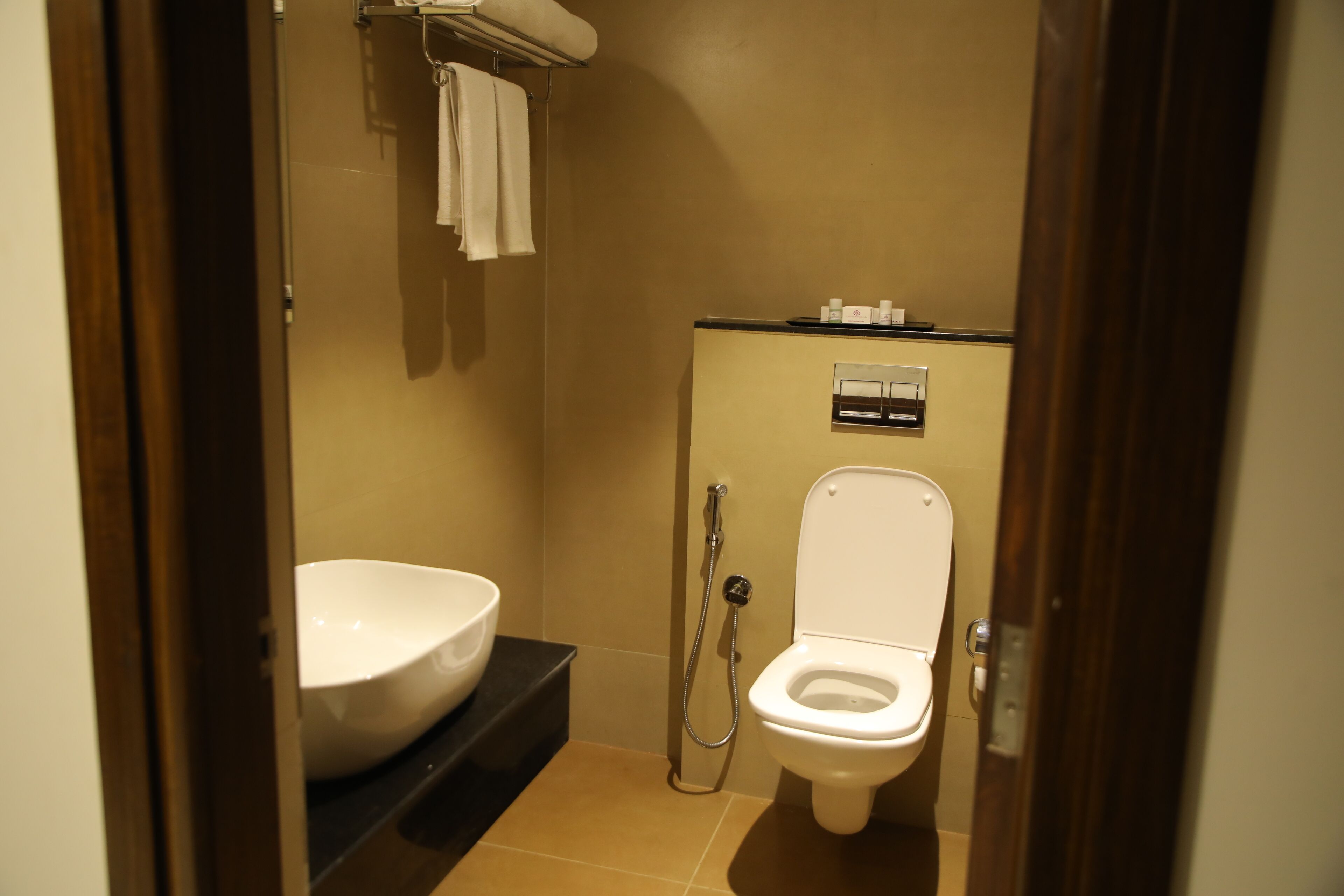 A small bathroom with a sink, toilet, and shower.