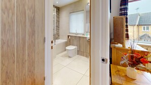 Ein modernes Badezimmer mit Toilette, Waschbecken und Dusche.