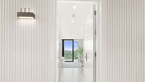 A modern hotel corridor with a view to a balcony and a number display on the wall. - B-603 (Cupecoy)