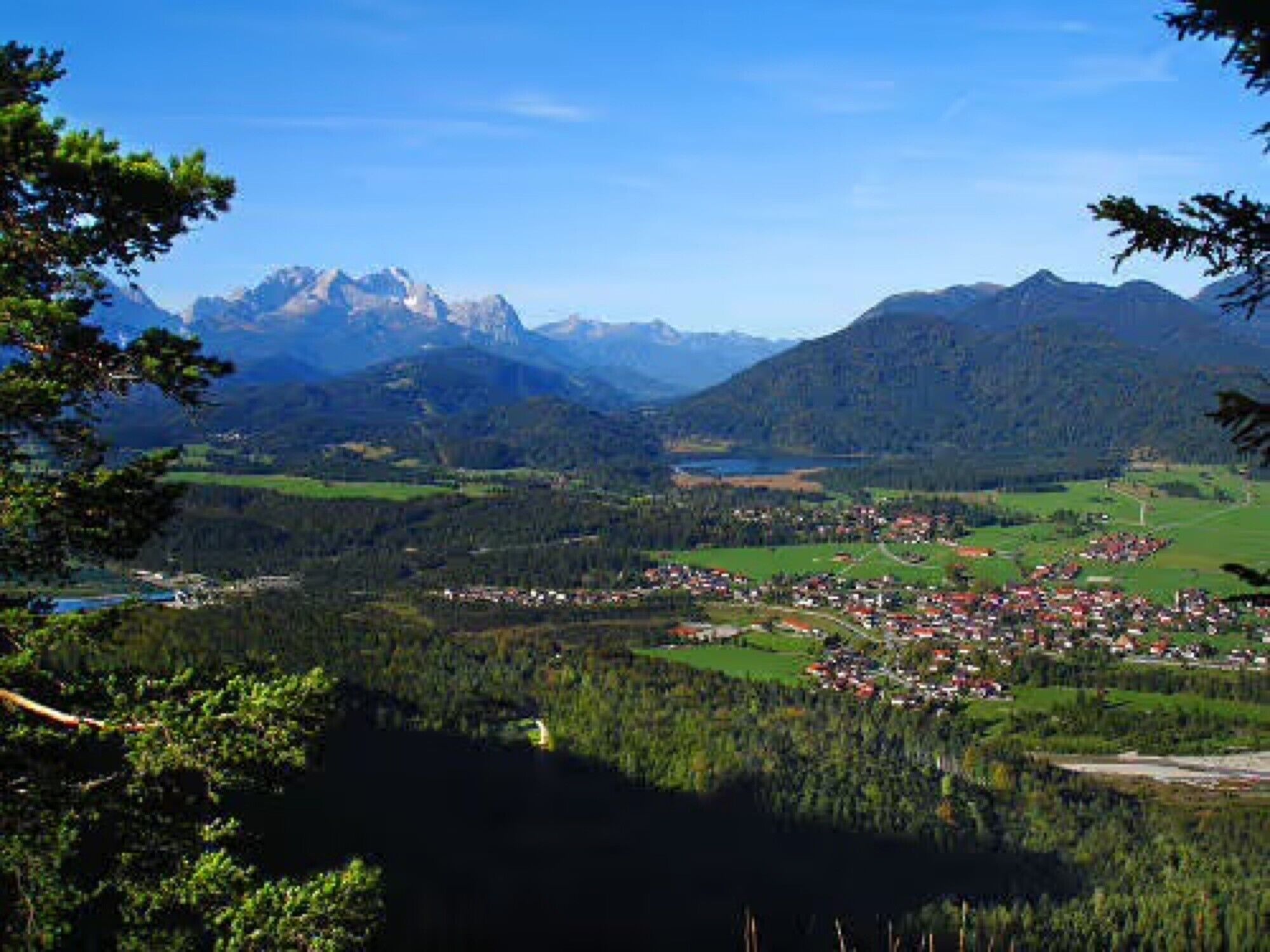 A mountainous landscape with a village nestled in the valley.