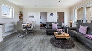 Un salon moderne comprenant un coin repas, un canapé et une table basse.