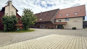 A building with a red-tiled roof, a chimney, and a sign that reads 'H&S Schutterle.'