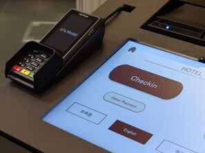 A payment terminal with a screen displaying "M's Hotel" and a check-in interface with options for "Other Payment" and language selection. - HOTEL Tomiya with M's (Kyoto)