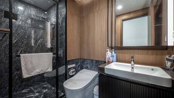 Deluxe Apartment, 3 Bedrooms, Balcony, City View | Bathroom | Shower, hydromassage showerhead, hair dryer, slippers