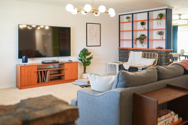 Modern comfort meets vibrant design in this cozy, stylish living space.