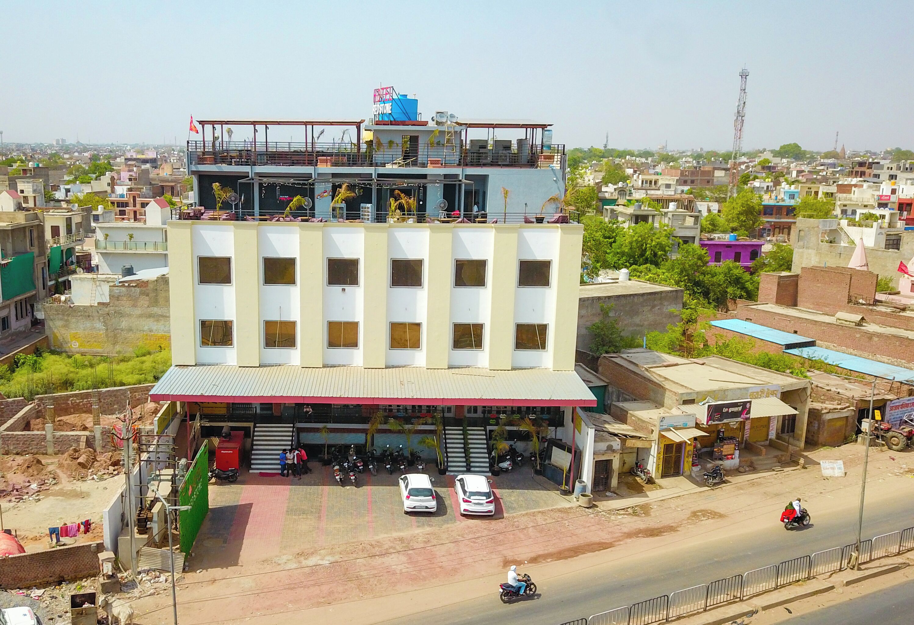 A multi-story building with a flat roof and a ground-level entrance.