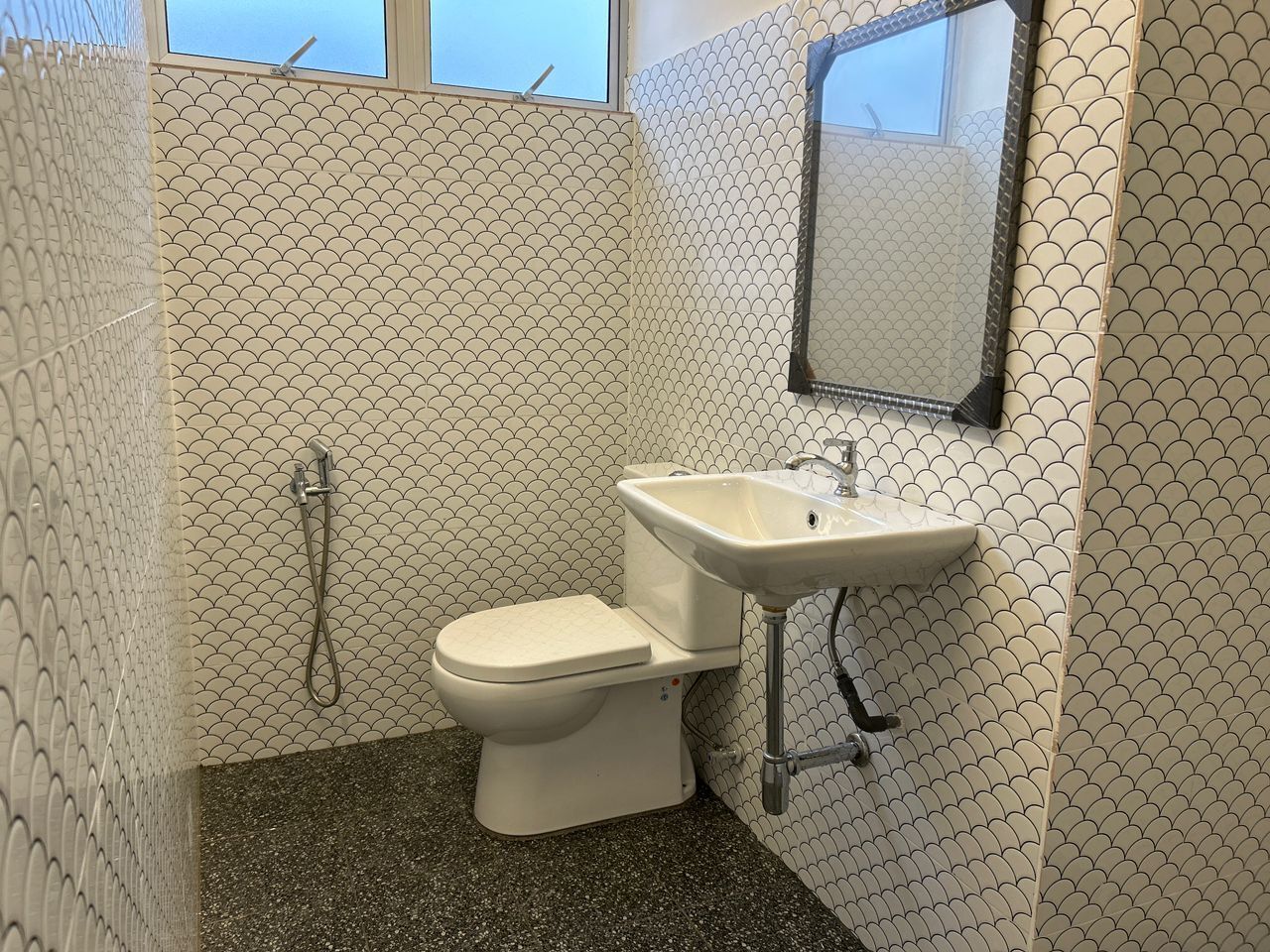 A bathroom with a toilet, sink, and shower.