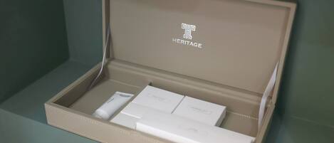 A beige box with the word "HERITAGE" on the lid, containing several white boxes labeled "SHOWER BATH" and "SHOWER CUB."