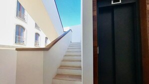 A staircase with wooden steps leading to a dark door.