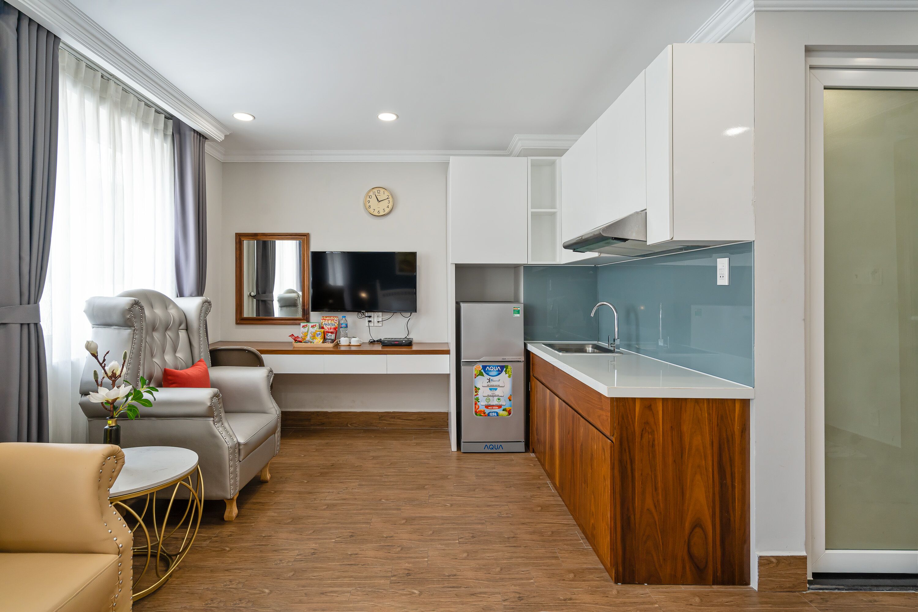 A modern kitchen with white cabinets, a wooden countertop, and a built-in sink.